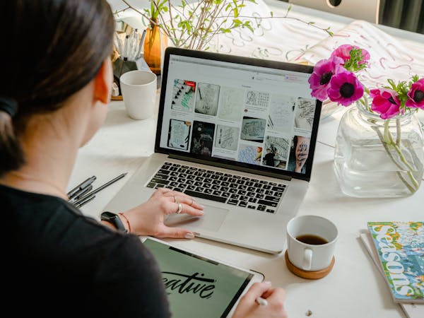 Artist uploading artwork portfolio on laptop